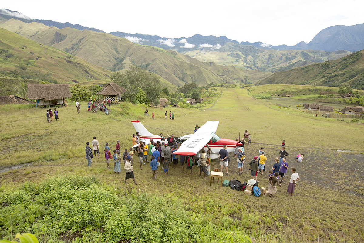 plane landing in a tribe in Papua New Guinea